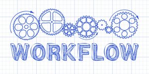 Workflow text with gear wheels hand drawn on graph paper background
